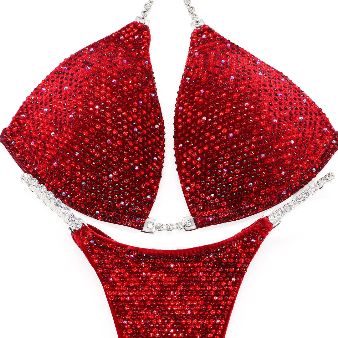 The Olympian Red Angel Shimmer, velvet red competition suit adorned with Light Siam, Siam, and Light Siam AB crystals for ultimate stage sparkle.