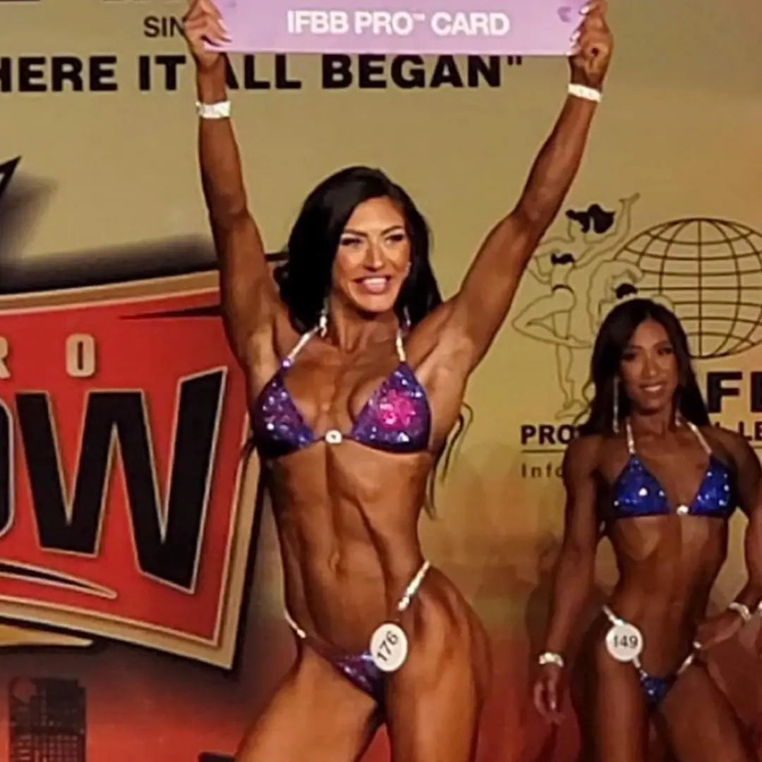 Annelle's Pro Card Nova, the epitome of elegance and strength for NPC Bikini or Wellness athletes. Designed with Annelle Petitpas, it showcases beautiful fuchsia and purple hues in unique designs. Elevate your stage presence with this striking suit, embodying confidence and style like never before.