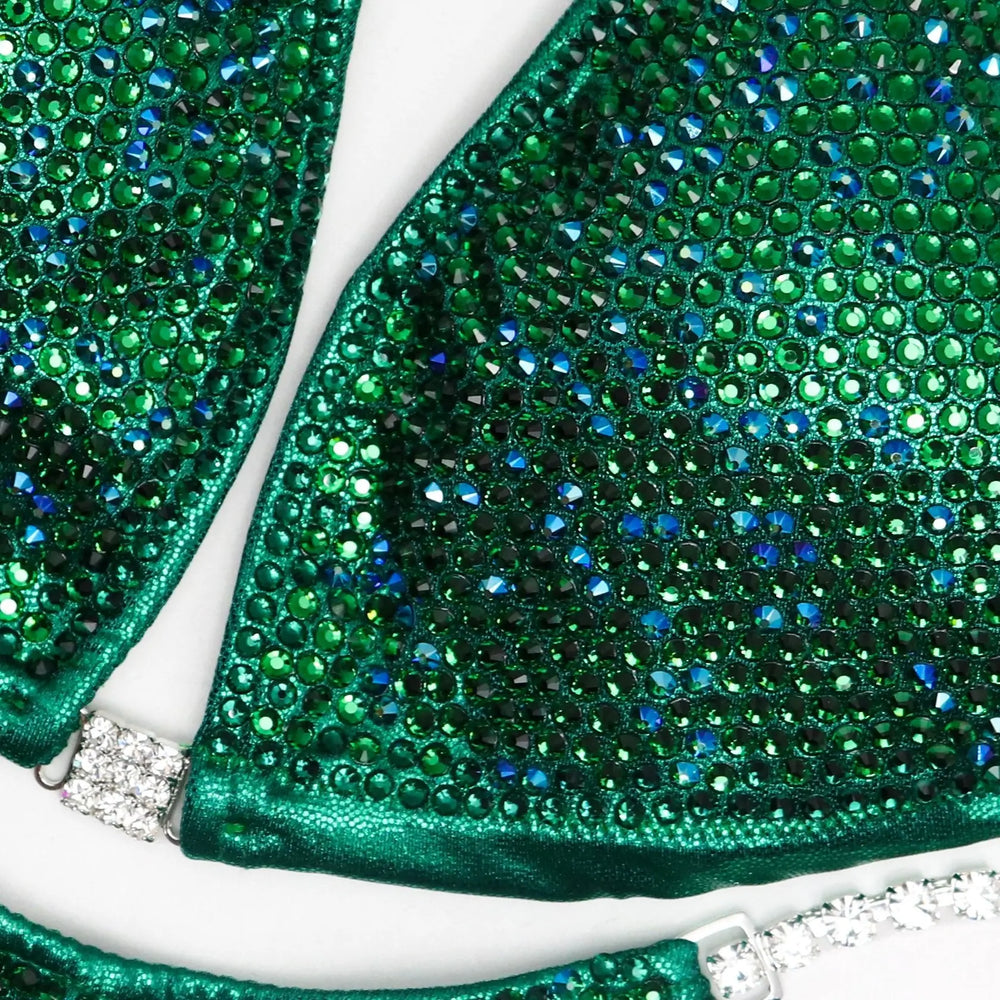 Ashley Kaltwasser's Lucky Charm Nova Competition Suit for NPC Bikini Competitors in vibrant green. Elevate your stage presence with this captivating design. Shine like a charm and dominate with confidence. Stand out as a true champion in this exclusive suit.