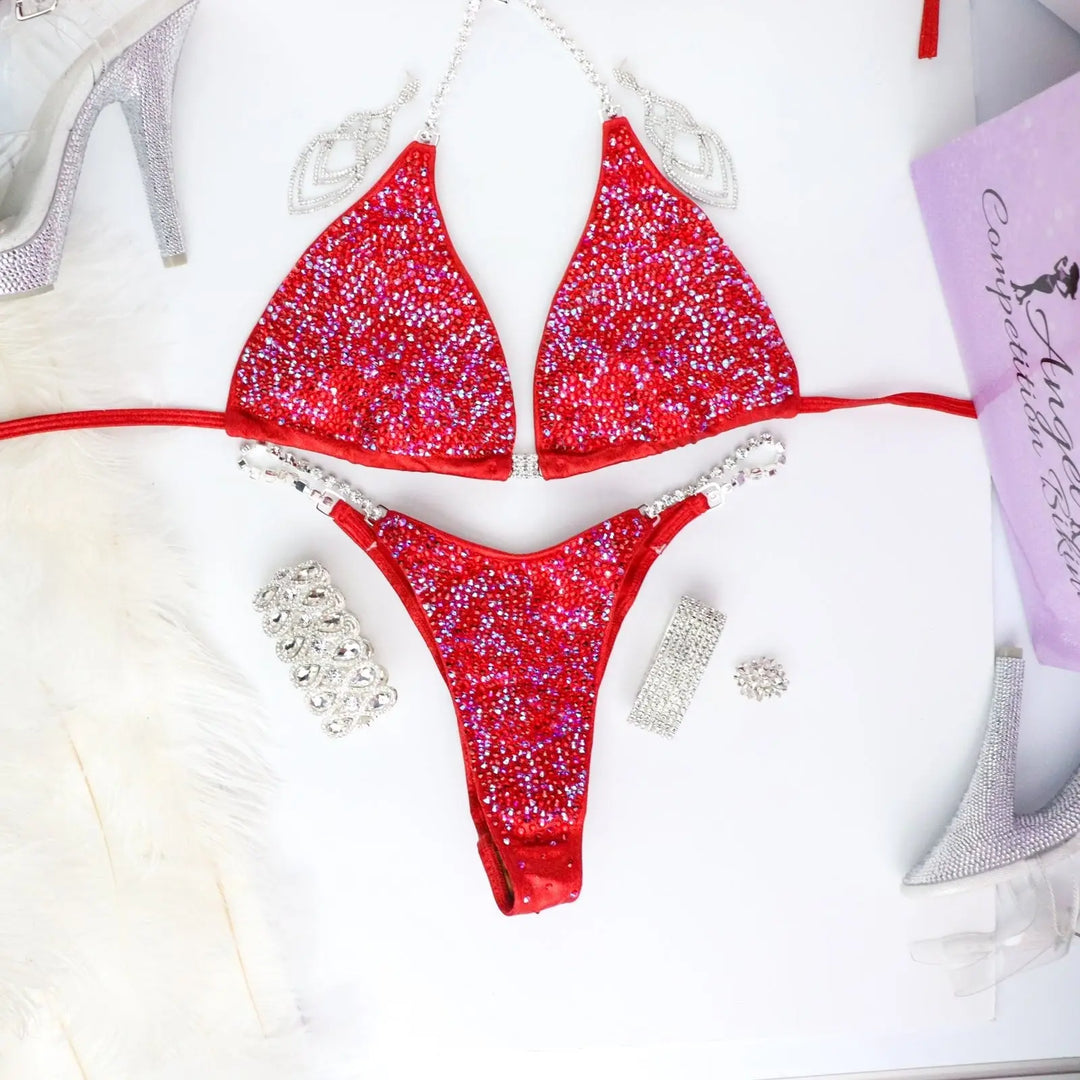 Introducing Ashley's Signature Red 2021 Radiance, a top-selling suit from Angel Competition Bikinis. Inspired by powerful women, it boasts stunning red hues that complement every skin tone and shape. Elevate your stage presence with this timeless and captivating design.