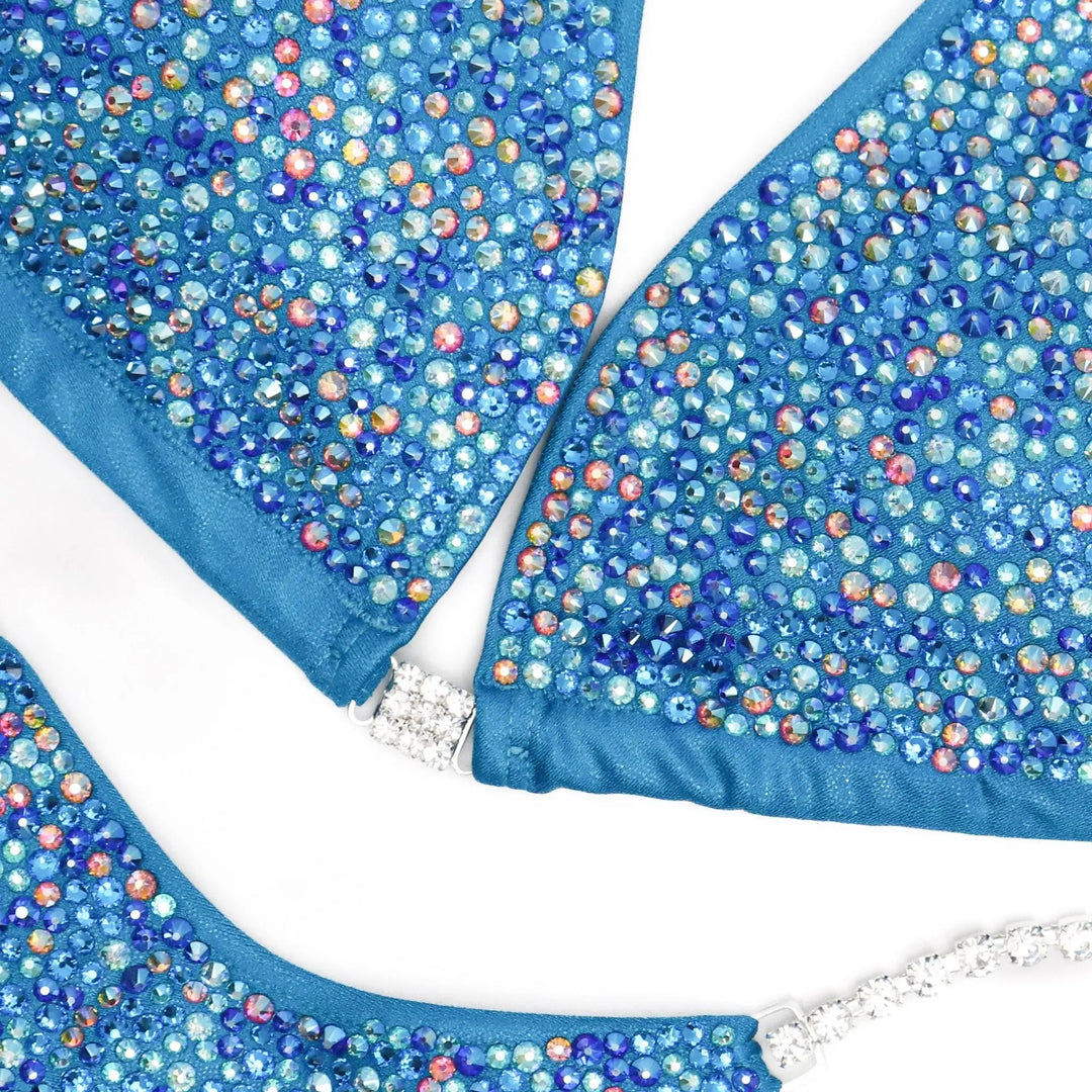 "Introducing Isa's Aquamarine Dream Radiance: The ultimate suit to illuminate your stage presence. Designed to bring out confidence in all female bodybuilders, this ensemble shines with regal elegance, empowering you to own the spotlight with grace and power. 💎✨ #FemaleBodybuilding #StageConfidence"