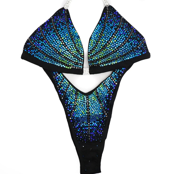 "Unleash your star power with Midnight Seafoam Galaxy! 💫💙 This captivating blue bodybuilding suit boasts a mesmerizing fade of green to blue crystals, ensuring you shine bright on stage. Elevate your performance with this celestial design! #BodybuildingGlam #MidnightSeafoam #GalaxyGlow"