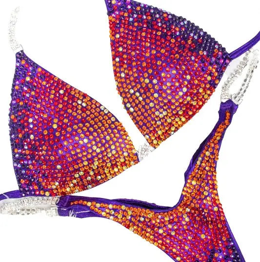 Purple Rainbow Trinity. Our custom-designed Purple Competition Suit is crafted for NPC Bikini and Wellness competitions, exuding charm with meticulous crystal work. This Purple Wellness Bikini, available at Angel Competition Bikinis, complements a wide range of skin tones, embodying both style and fitness.