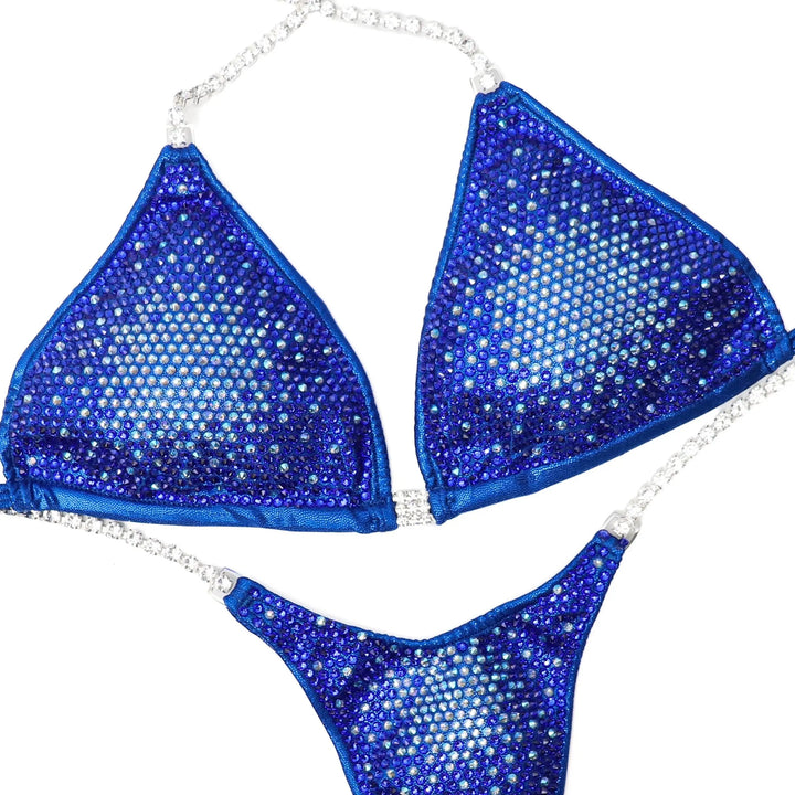 "Introducing Sapphire Nova 💙✨ This mesmerizing blue suit transitions from light to dark, creating a stunning gradient effect 🌟 Perfect for all female bodybuilders looking to make a statement on stage! #Bodybuilding #CompetitionSuit #SapphireNova 🏋️♀️💎"