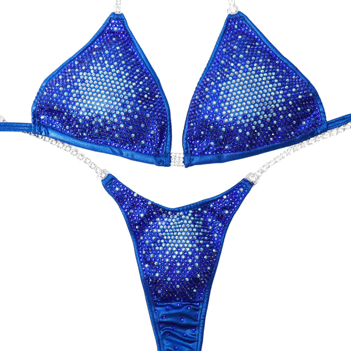 "Introducing Sapphire Nova 💙✨ This mesmerizing blue suit transitions from light to dark, creating a stunning gradient effect 🌟 Perfect for all female bodybuilders looking to make a statement on stage! #Bodybuilding #CompetitionSuit #SapphireNova 🏋️♀️💎"