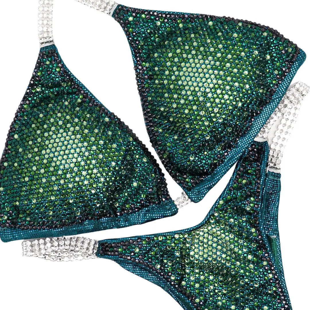 Introducing Turtle Teal Nova: a mesmerizing teal competition suit featuring a gradient of Peridot AB, Fern, Emerald, and Graphite crystals. Stand out on stage with this unique and stunning design! 🐢💎✨ #Bodybuilding #CompetitionSuit #TurtleTealNova #CrystalGradient