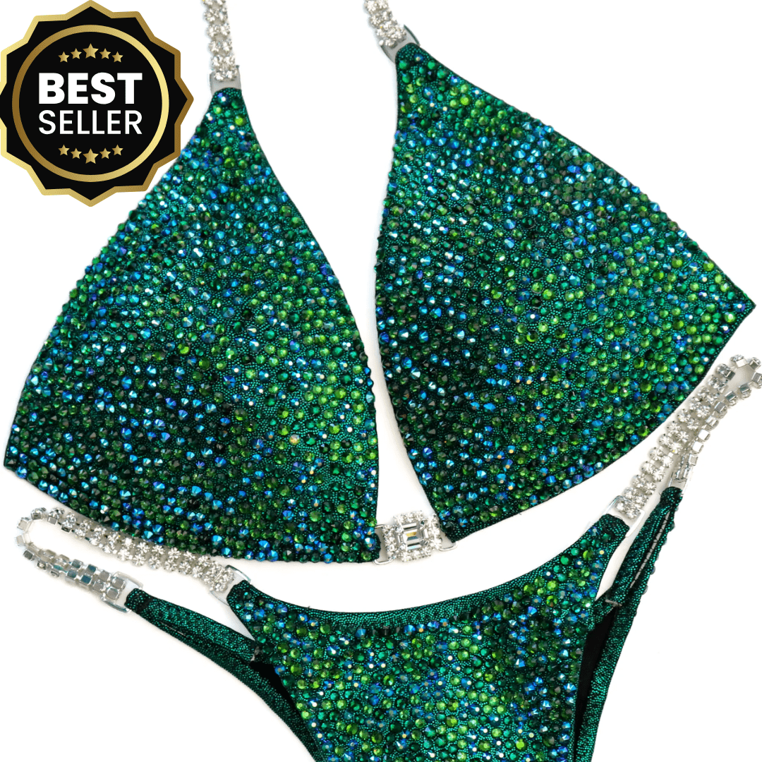 Kimber's Lucky Charm Radiance emerald hologram bikini with Emerald AB, Fern, and crystal accents for bodybuilding competition suits