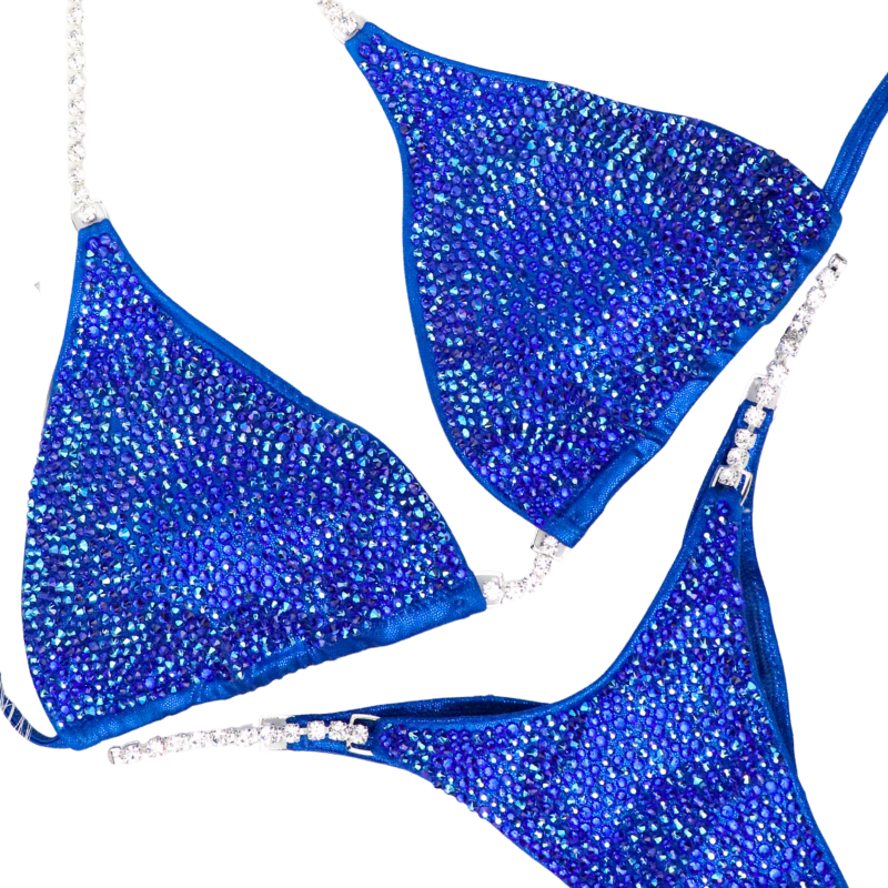Introducing Cobalt Radiance, the epitome of elegance for female bodybuilding competitors. This shimmering blue suit is designed to light up the stage, igniting your inner confidence. Perfect for all female competitors ready to rock the stage with unparalleled grace and style.