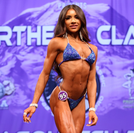 Introducing Tianna's Purple Radiance competition suit, a stunning Electric Purple adorned with vibrant blue crystals that illuminate both the suit and the stage. ✨💜 Perfect for female bodybuilders looking to shine with elegance and sophistication. Stand out and sparkle with every pose! #Bodybuilding #CompetitionSuit #PurpleRadiance #FemaleAthlete