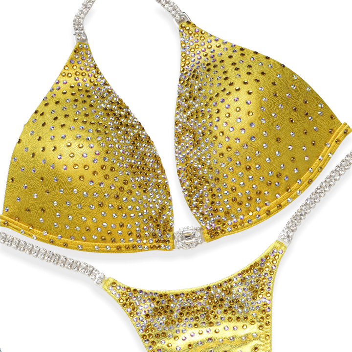 Golden yellow bikini with ombre crystal shimmer design and rhinestone straps on a white background