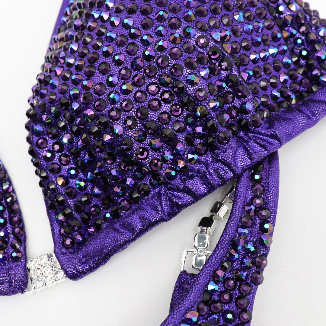 Introducing the Victorious Violet Diamond Pro: an Hologram Eggplant competition suit adorned with Chrome Purple AB and Violet crystals! 💎💜 Stand out on stage with its shimmering elegance and powerful presence. Perfect for those who want to showcase their strength and style! #BodybuildingSuit #CompetitionReady #VictoriousVioletDiamondPro