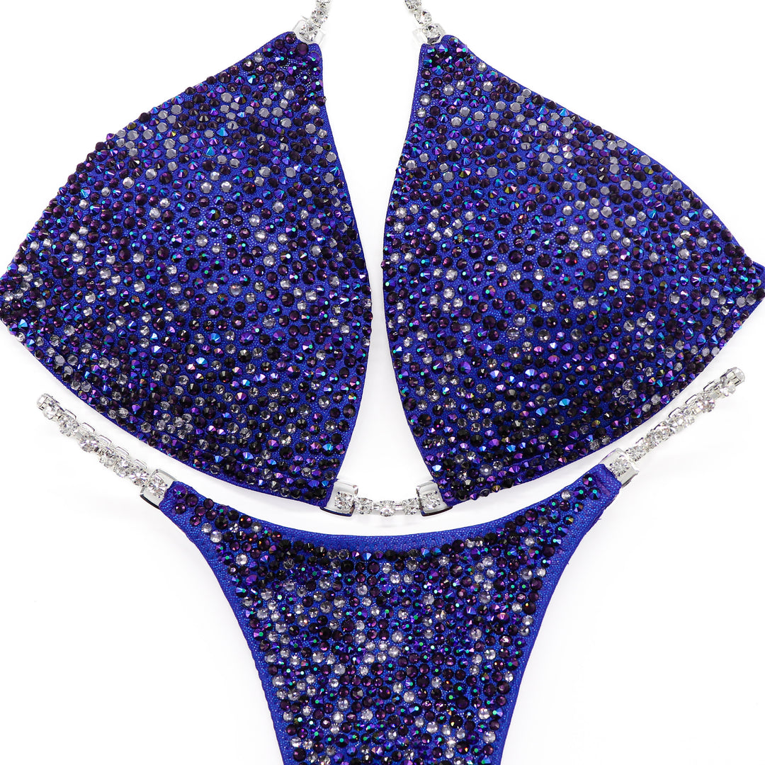 Introducing Violet Storm Radiance: a stunning purple competition suit adorned with Violet, Tanzanite, and Chrome Purple AB crystals—a perfect storm of elegance and strength! 💜✨ Stand out on stage with this dazzling ensemble that captures attention effortlessly. #BodybuildingSuit #CompetitionReady #VioletStormRadiance