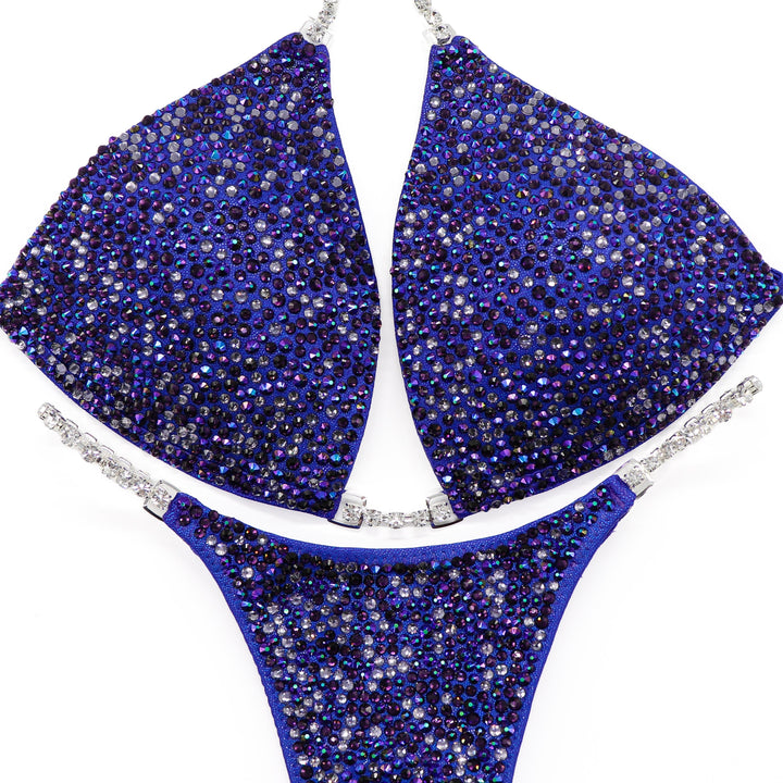 Introducing Violet Storm Radiance: a stunning purple competition suit adorned with Violet, Tanzanite, and Chrome Purple AB crystals—a perfect storm of elegance and strength! 💜✨ Stand out on stage with this dazzling ensemble that captures attention effortlessly. #BodybuildingSuit #CompetitionReady #VioletStormRadiance