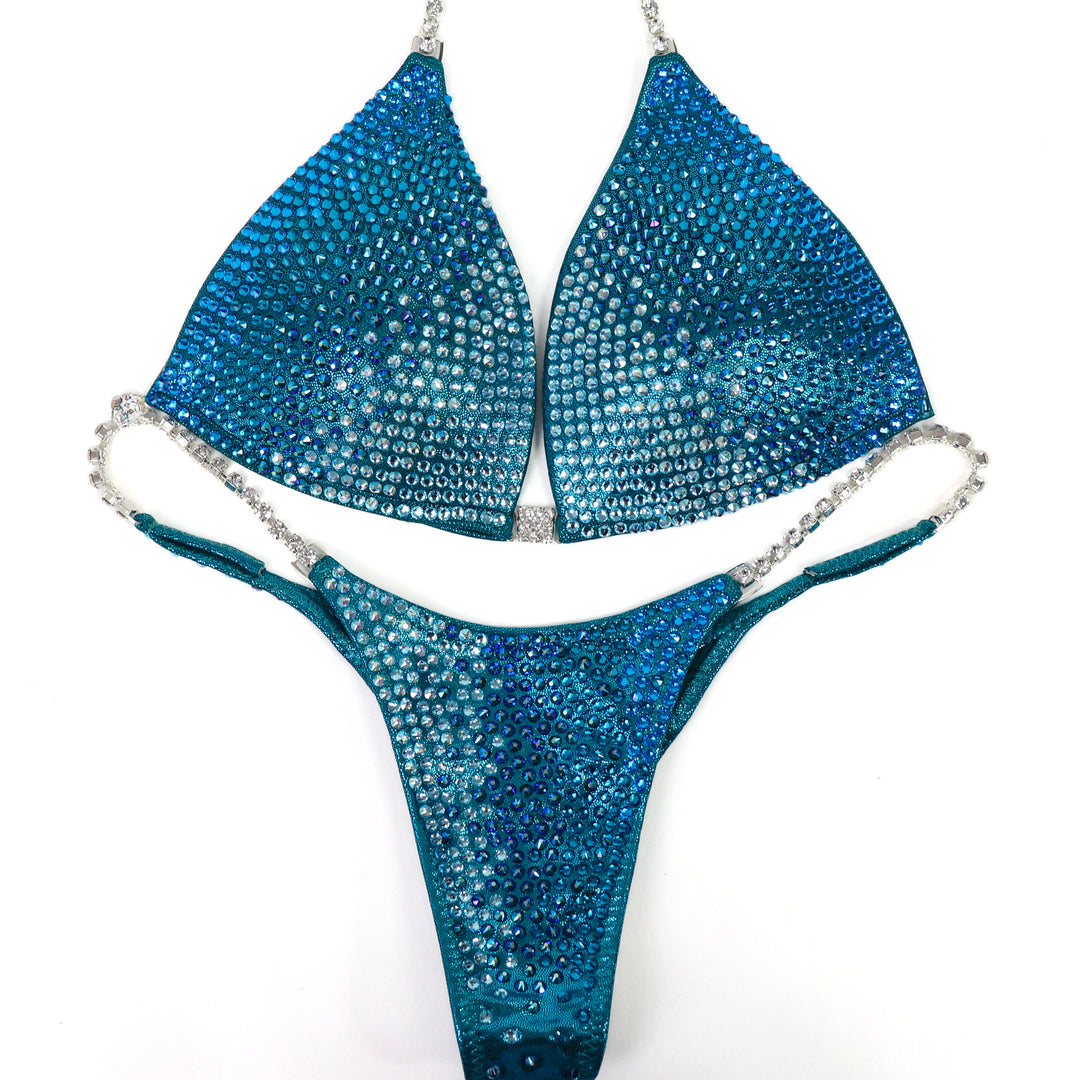 QS ST: Capri Cascade Glow. Hologram Teal. Medium Molded/Pro.  Angel Competition BikinisThe best NPC Competition Suits for the Bikini Division, Fit Model Division Suits, and bodybuilding suits.