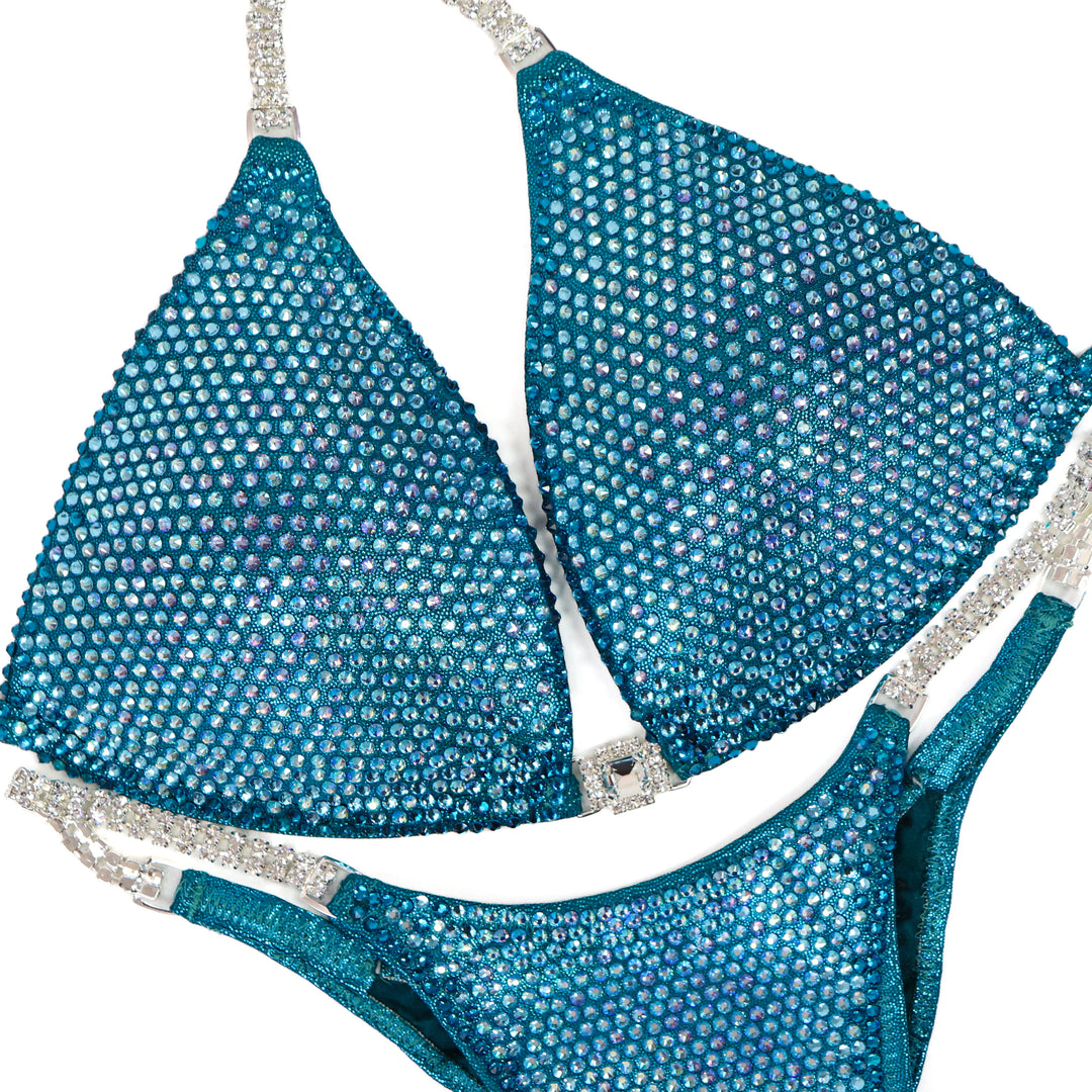 QS ST: Kassandra Gillis Teal Nova. Medium Molded/Pro.  Angel Competition BikinisThe best NPC Competition Suits for the Bikini Division, Fit Model Division Suits, and bodybuilding suits.