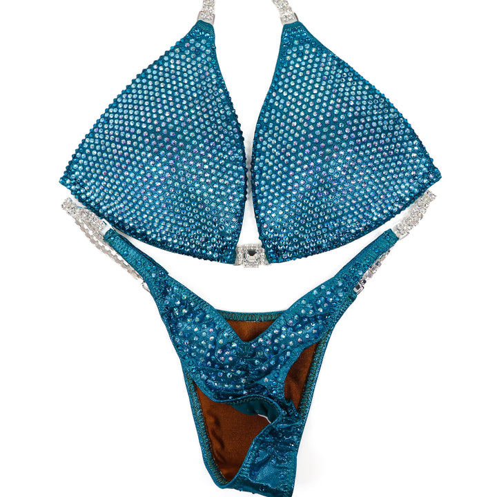 QS ST: Kassandra Gillis Teal Nova. Medium Molded/Pro.  Angel Competition BikinisThe best NPC Competition Suits for the Bikini Division, Fit Model Division Suits, and bodybuilding suits.