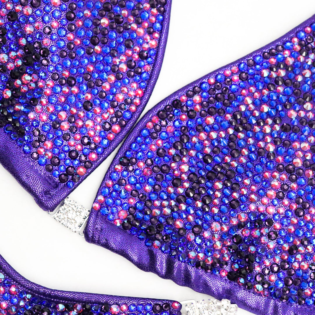 Introducing Lucia's Purple Disco Radiance! Shine like a star on stage with this eggplant suit adorned with fuchsia, sapphire, and violet crystals. 💜 Designed to make you stand out! #Bodybuilding #CompetitionSuit #PurpleDiscoRadiance 💪🌟