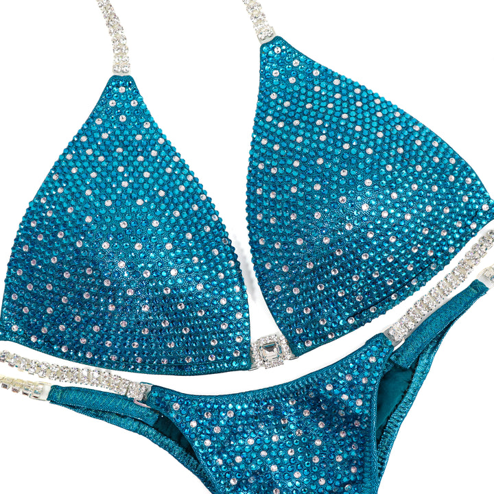 QS ST: Teal Angel Shimmer. Medium Molded/Pro.  Angel Competition BikinisThe best NPC Competition Suits for the Bikini Division, Fit Model Division Suits, and bodybuilding suits.
