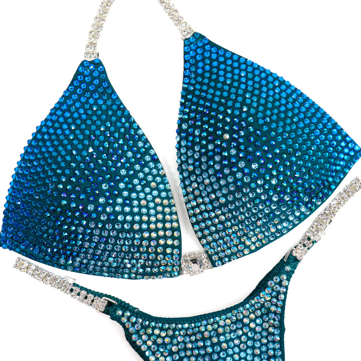 QS ST: Capri Cascade Glow. Matte Teal. Medium Molded/Pro.  Angel Competition BikinisThe best NPC Competition Suits for the Bikini Division, Fit Model Division Suits, and bodybuilding suits.