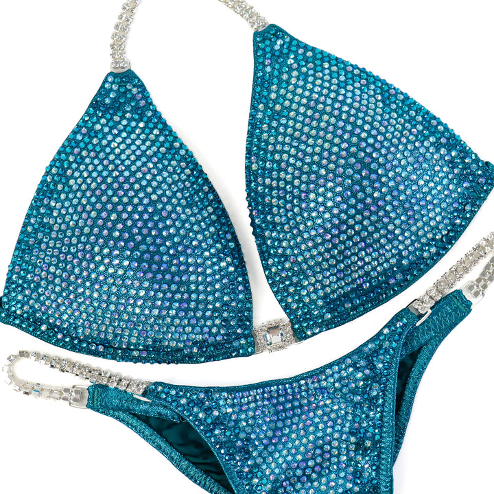 Kassandra Gillis's Teal Nova  Angel Competition BikinisThe best NPC Competition Suits for the Bikini Division, Fit Model Division Suits, and bodybuilding suits.