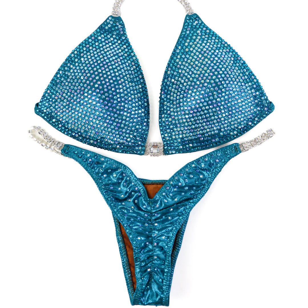 QS ST: Kassandra Gillis Teal Nova. Medium Molded/Pro.  Angel Competition BikinisThe best NPC Competition Suits for the Bikini Division, Fit Model Division Suits, and bodybuilding suits.