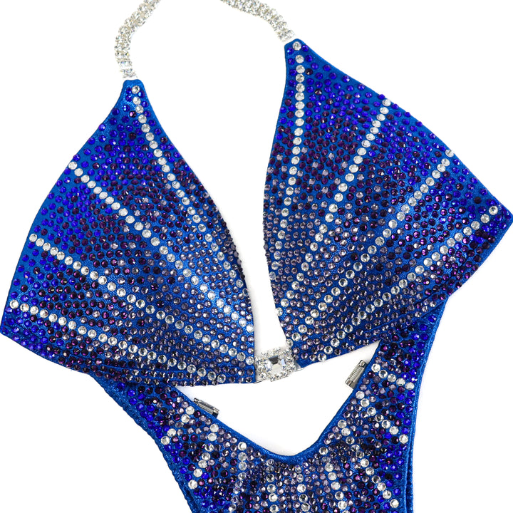 Introducing the Blue Amethyst Galaxy competition suit, a stunning choice for female figure competitors. With its unique design and beautiful colors, this suit ensures you'll dazzle on stage. Stand out and make a statement with this captivating piece.