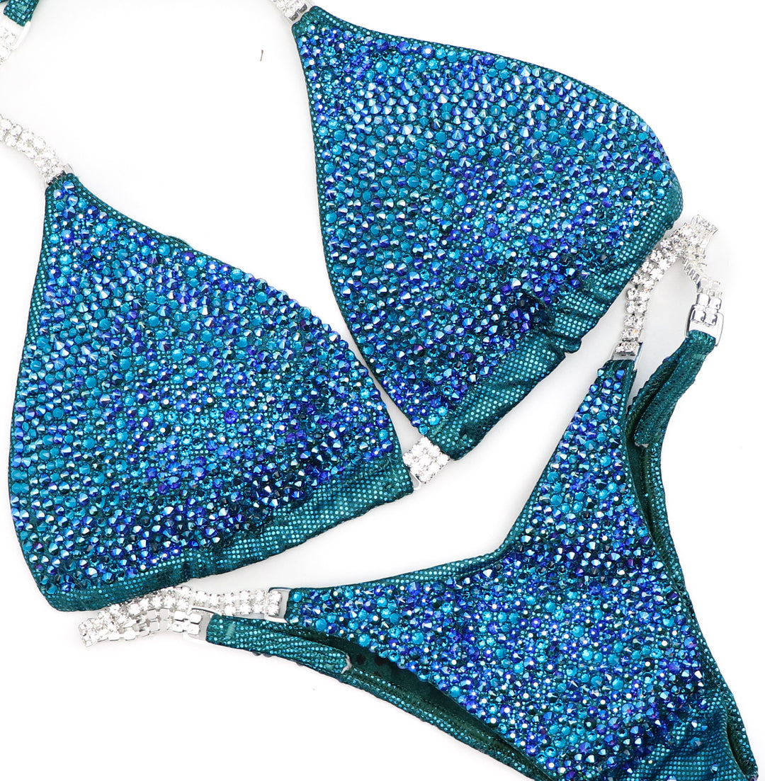 Introducing Jennifer's Teal Radiance competition suit! 💎 Sparkling teal adorned with confidence, designed to shine on stage like never before. Elevate your performance with Jennifer Capozzi's signature style! #ShineBright #ConfidenceBoost #StageGoddess 💪🌟