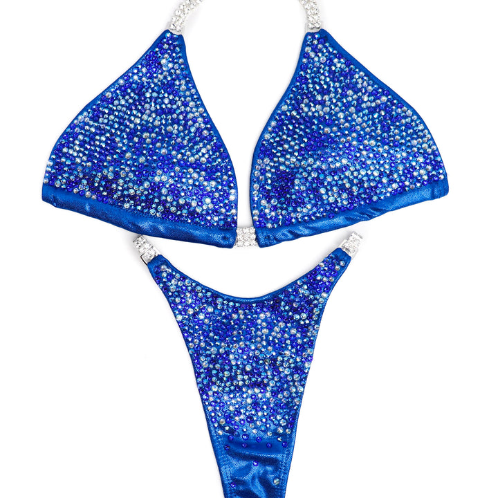 Introducing Phoebe Hurricane Blue Radiance 💙! This electric blue competition suit features stunning shades of blue crystals, ensuring you light up any stage with brilliance ✨. Stand out in style! #Bodybuilding #CompetitionSuit #HurricaneBlueRadiance 💪👗🌟