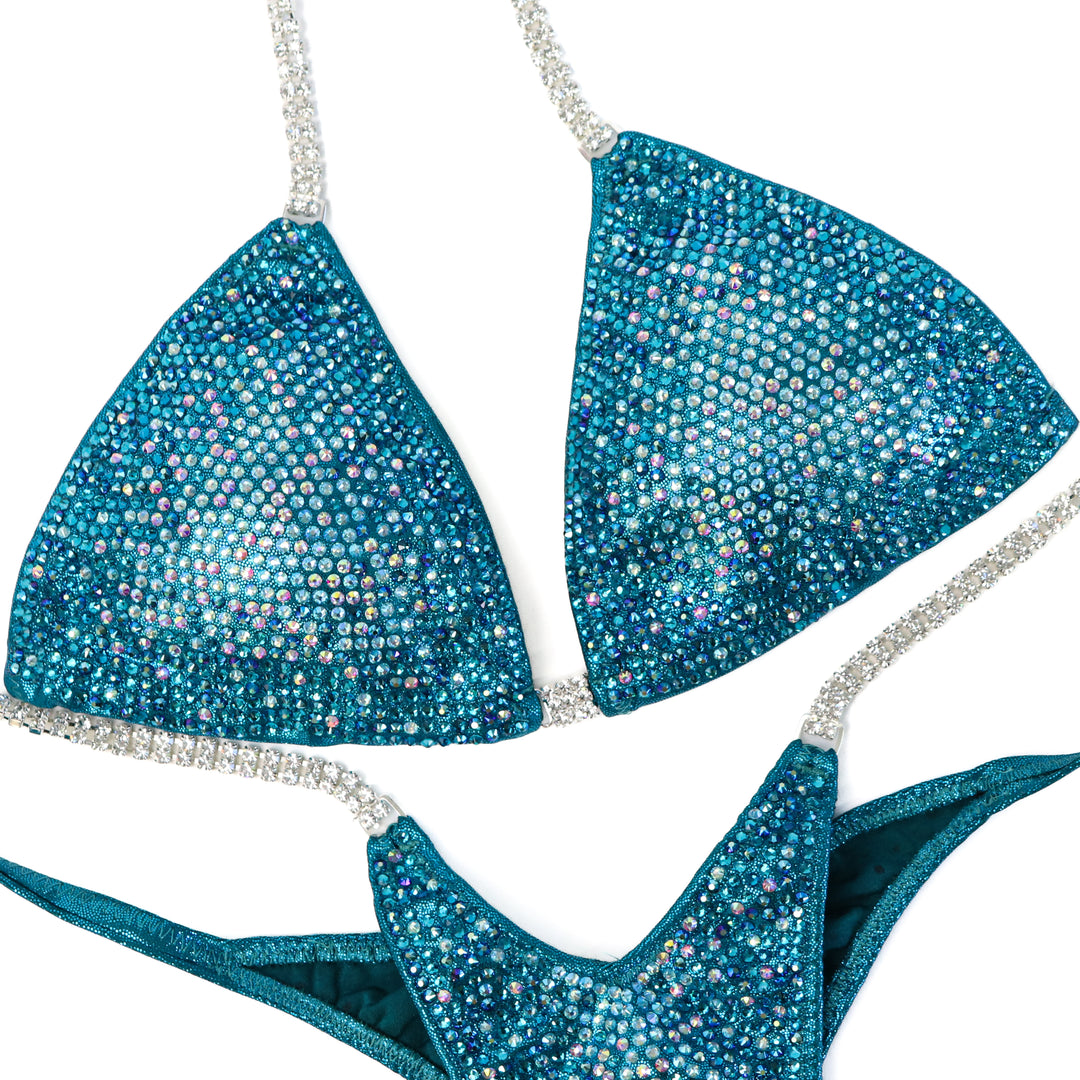 QS ST: Teal Nova. Medium/Pro with Modest Rise.  Angel Competition BikinisThe best NPC Competition Suits for the Bikini Division, Fit Model Division Suits, and bodybuilding suits.