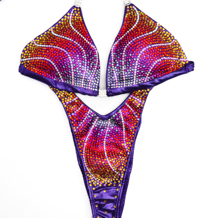 Introducing Purple Rainbow Crystal Flare 🌈! This newly added design boasts crystal AB, purple, fuchsia, red, tangerine, and sunflower crystals, ensuring a one-of-a-kind suit that radiates elegance and uniqueness on stage. #Bodybuilding #CompetitionSuit #CrystalFlare 💜👗🌟