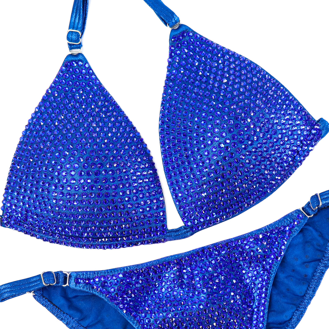 QS ST: Crystallized Hologram Electric Blue Fit Model Suit. Medium Molded/Fit Model 2.  Angel Competition BikinisThe best NPC Competition Suits for the Bikini Division, Fit Model Division Suits, and bodybuilding suits.