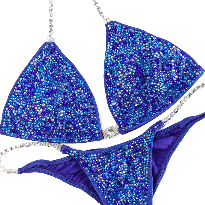QS ST: Crystal Radiance. Hologram Electric Purple. Large/Pro with Modest Rise.  Angel Competition BikinisThe best NPC Competition Suits for the Bikini Division, Fit Model Division Suits, and bodybuilding suits.