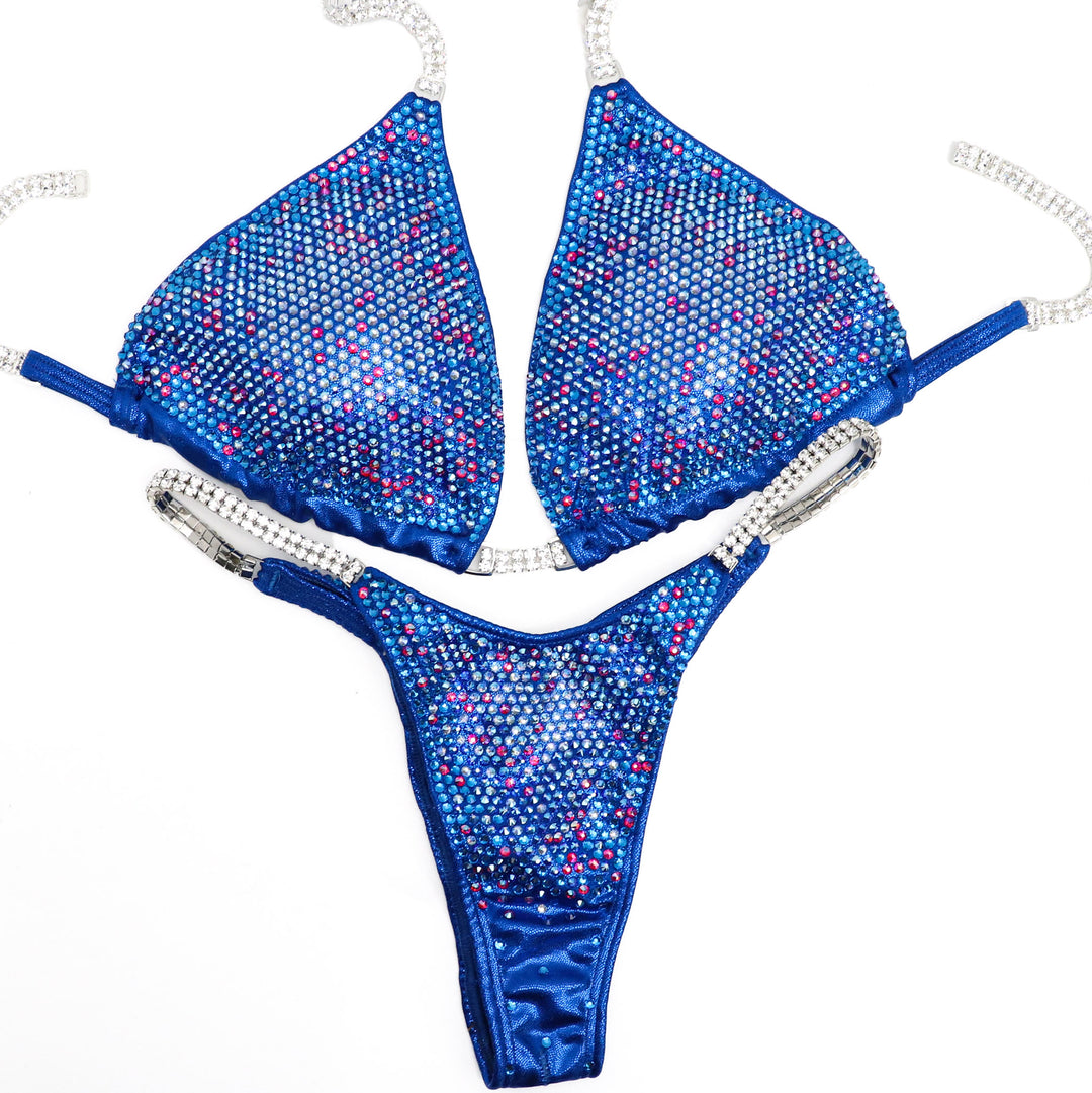 Introducing Electric Blue Fuchsia Nova: a standout in female bodybuilding attire. With its electric blue hue and touches of fuchsia, this suit boasts a unique design that ignites inner confidence. Illuminate the stage and own your power with this striking ensemble. 💪💙 #FemaleBodybuilding #ConfidenceBoost