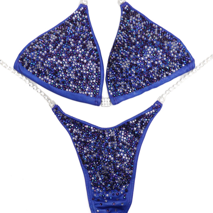  Electric Purple Competition Suit, tailored for NPC Bikini competitors. Elevate your stage presence with its vibrant hue and sleek design. Crafted for performance and style, it's ready to ship for your next competition. Make a statement and stand out confidently.