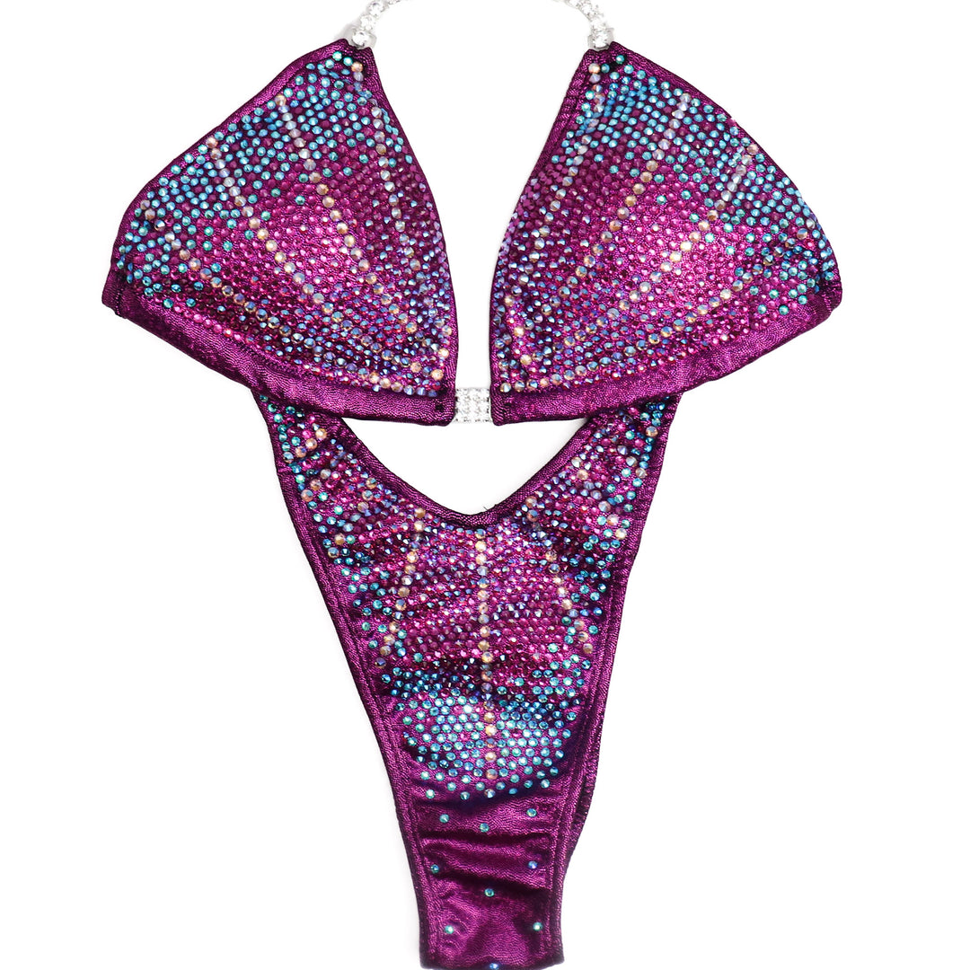 The Raspberry Galaxy Competition Suit, designed for female figure competitors. With its mesmerizing blend of unique raspberry hues and celestial sparkles, this suit ensures you stand out on stage with elegance and confidence. Dominate the competition and shine like a star.