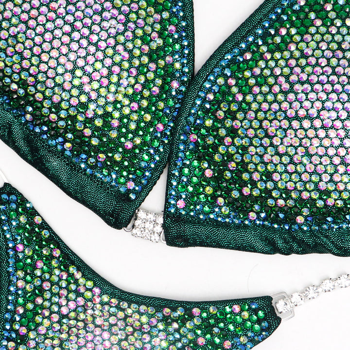 Nina's Emerald Nova Competition Suit, tailored for NPC Bikini or Wellness Competitors. Dazzle on stage with its beautifully radiant green hue, exuding elegance and confidence. Elevate your performance, shine like a star, and make every moment count.