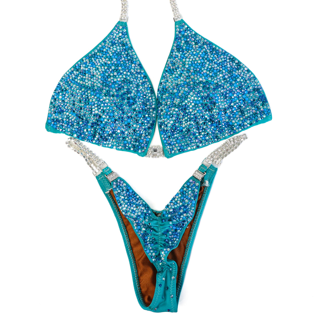 Pre Owned: Matte Aqua Crystal Radiance. Large/Pro.  Angel Competition BikinisThe best NPC Competition Suits for the Bikini Division, Fit Model Division Suits, and bodybuilding suits.