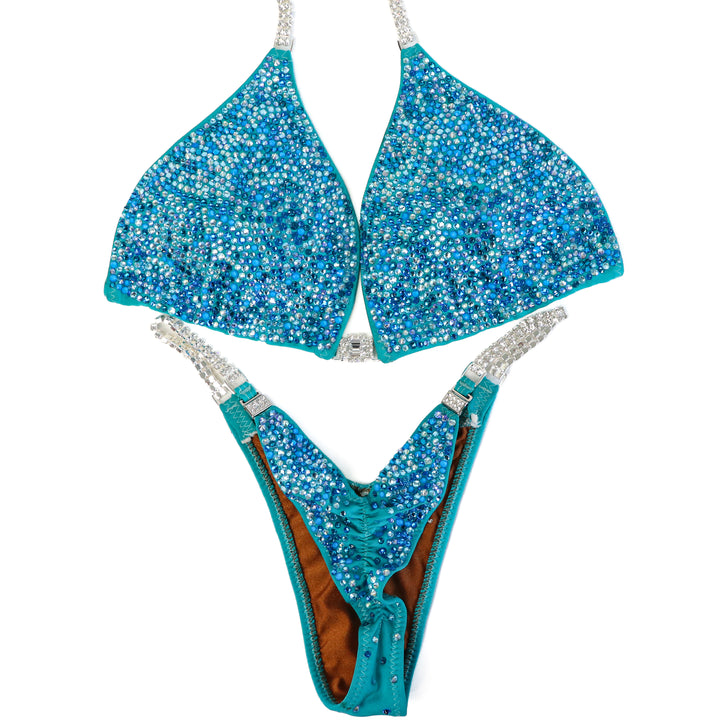 Pre Owned: Matte Aqua Crystal Radiance. Large/Pro.  Angel Competition BikinisThe best NPC Competition Suits for the Bikini Division, Fit Model Division Suits, and bodybuilding suits.