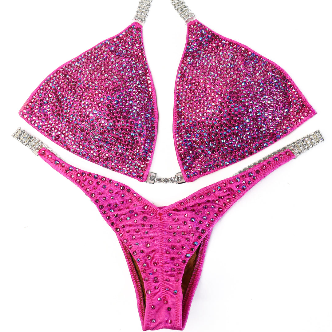 QS ST: Lucia's Pink Radiance. Hologram Pink. Medium/Pro, Petite Rise.  Angel Competition BikinisThe best NPC Competition Suits for the Bikini Division, Fit Model Division Suits, and bodybuilding suits.