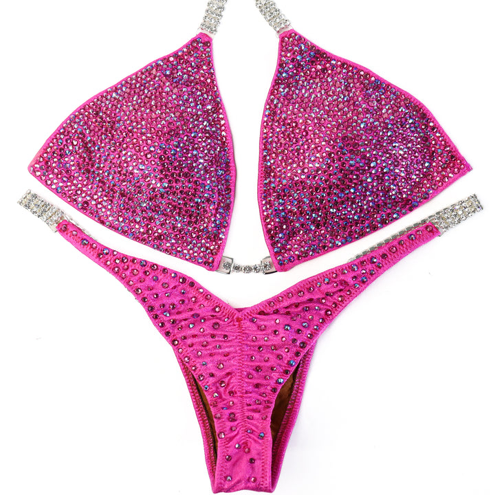 QS ST: Lucia's Pink Radiance. Hologram Pink. Medium/Pro, Petite Rise.  Angel Competition BikinisThe best NPC Competition Suits for the Bikini Division, Fit Model Division Suits, and bodybuilding suits.