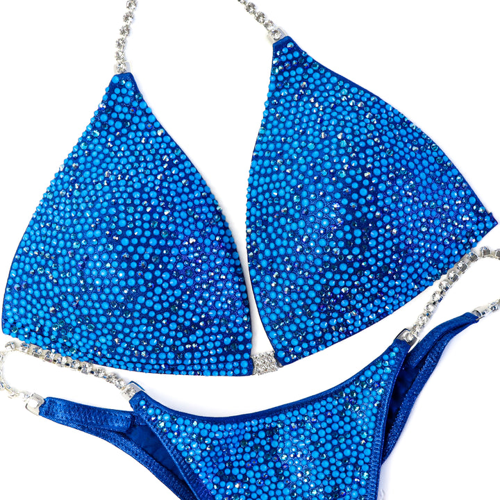 QS ST:  Blue Lagoon Radiance. Large/Pro, Modest Rise.  Angel Competition BikinisThe best NPC Competition Suits for the Bikini Division, Fit Model Division Suits, and bodybuilding suits.