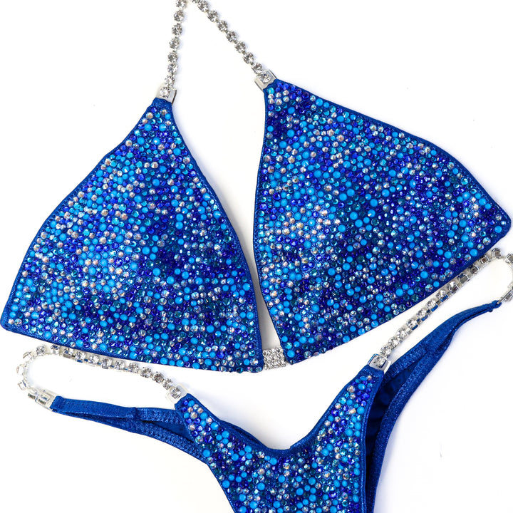 QS ST: Neon Blue Horizon Radiance. Medium/Wellness Micro.  Angel Competition BikinisThe best NPC Competition Suits for the Bikini Division, Fit Model Division Suits, and bodybuilding suits.