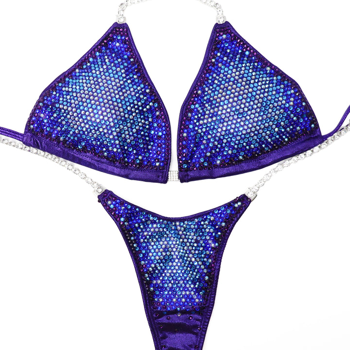 Introducing Eggplant Sunset Nova: the ultimate suit for female bodybuilding. With mesmerizing eggplant hue and hints of blue and purple, it promises to make you unstoppable on stage. Dominate with confidence in this stunning piece. 💪🌅 #FemaleBodybuilding #UnstoppableStyle
