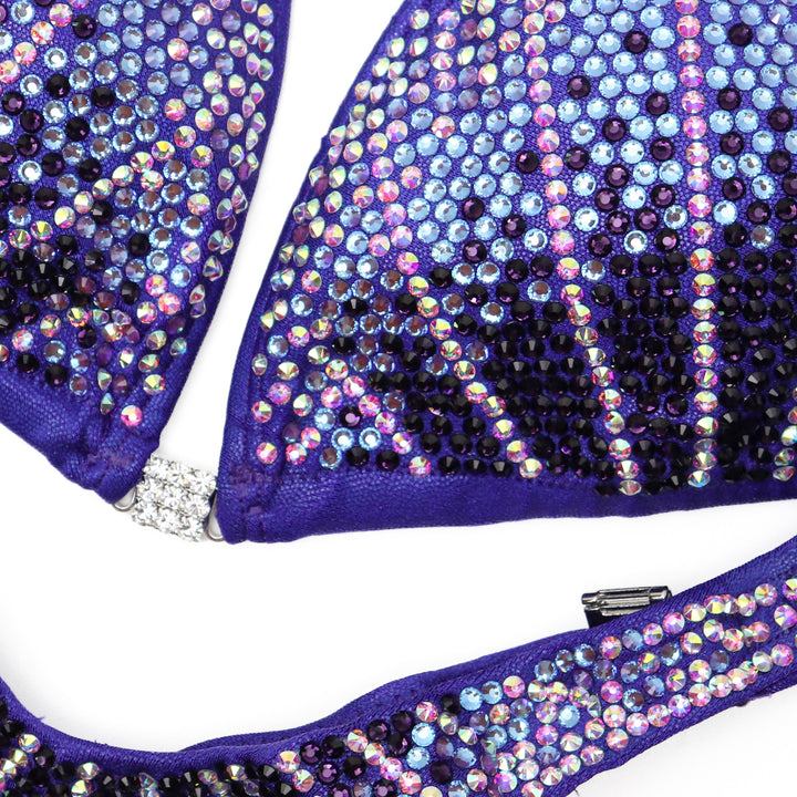 Introducing Purple Cosmo 💜! This stunning purple competition suit is adorned with purple and crystal burgundy crystals, ensuring you stand out on stage with elegance and flair ✨. #Bodybuilding #CompetitionSuit #PurpleCosmo 👙💎🌟