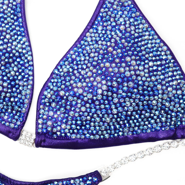 Shine on stage with our Purple Radiance Crystallized Bikini, designed for ultimate bikini confidence. This stunning suit features hand-applied crystals, ensuring perfect sparkle. Ready to ship for quick delivery, you'll be competition-ready in no time. Elevate your performance and showcase your best with confidence!