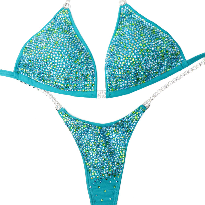 Introducing Peridot AB Radiance 💎! This matte aqua jade competition suit for female bodybuilding dazzles with stunning peridot and aqua crystals 💚. Light up the stage with this bright and beautiful attire! #Bodybuilding #CompetitionSuit #PeridotABRadiance ✨👙💚