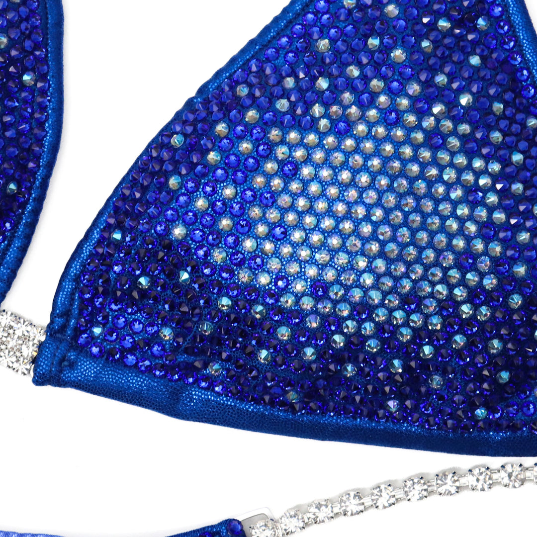 "Introducing Sapphire Nova 💙✨ This mesmerizing blue suit transitions from light to dark, creating a stunning gradient effect 🌟 Perfect for all female bodybuilders looking to make a statement on stage! #Bodybuilding #CompetitionSuit #SapphireNova 🏋️‍♀️💎"