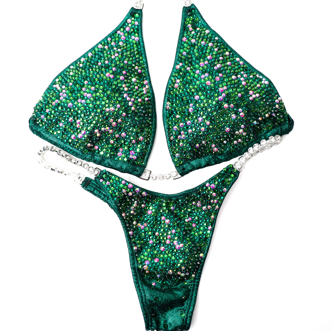 Turn heads with Kerigan's Emerald Radiance! 💚 This stunning emerald competition suit features Fern Green, Emerald, and a dash of Crystal AB for a sparkling finish. Shine bright and own the stage with Kerigan Pike! ✨🏆 #Bodybuilding #CompetitionSuit #EmeraldRadiance #FitnessFashion #StageGlam