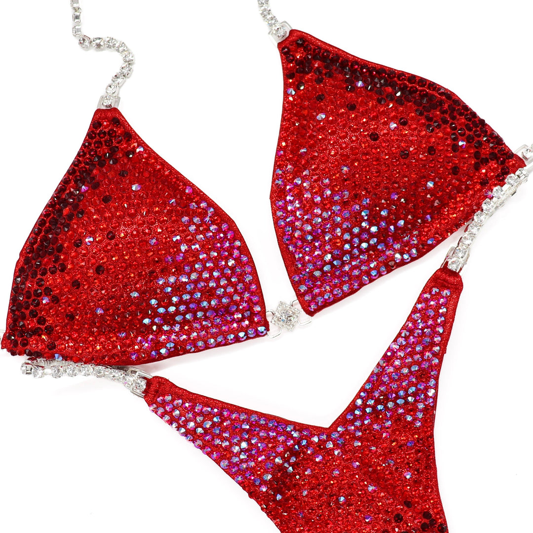Red crystal bikini set with gradient diamond design and silver chain straps for athletes and figure competitors