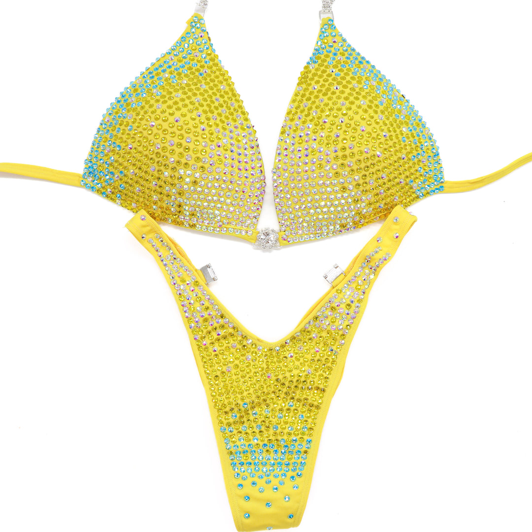 Shine bright in the **Sunny Splash Trinity**—a bold hologram yellow suit with Crystal AB, Sunflower, and Aqua AB crystals for ultimate stage sparkle.